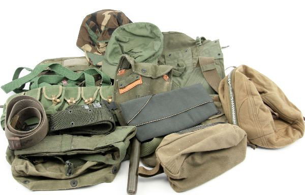 MIXED LOT OF MILITARY GEAR AND BAGS: Mixed lot of various military items and gear. Five various bags, including helmet bag; one magazine vest; three hats; and one folding shovel.