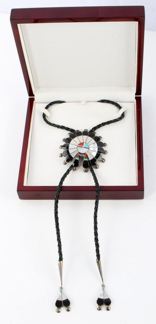 ZUNI SUNFACE STERLING SILVER WITH INLAY BOLO: Zuni Sunface southwestern bolo with leather strap, sterling silver, Mother of Pearl, coral, turquoise and onyx inlay. Diameter 3 inches