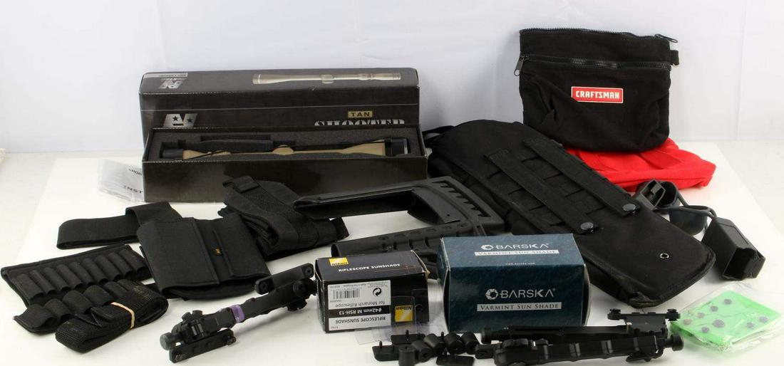 MIXED LOT OF GUN PARTS SCOPE HOLSTER STOCKS: Mixed lot includes: two polymer stock pieces (one Ruger), two pairs of bipod legs, large nylon holster (19 inches), two small cloth bags, NcStar 3-9 X 40 mm scope in box, Nikon rifle scope sunshade, B