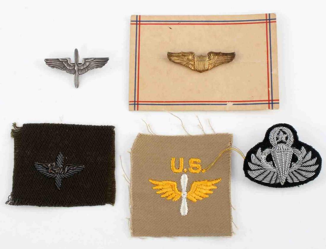 WWII ARMY AIR CORP WINGS INSIGNIA AIRBORNE: Includes 1 1/2 inch pilot wings on paper new old stock, sterling collar insignia. cloth and bullion collar insignia, Khaki insignia, and post war senior jump master bullion Airborne wings.