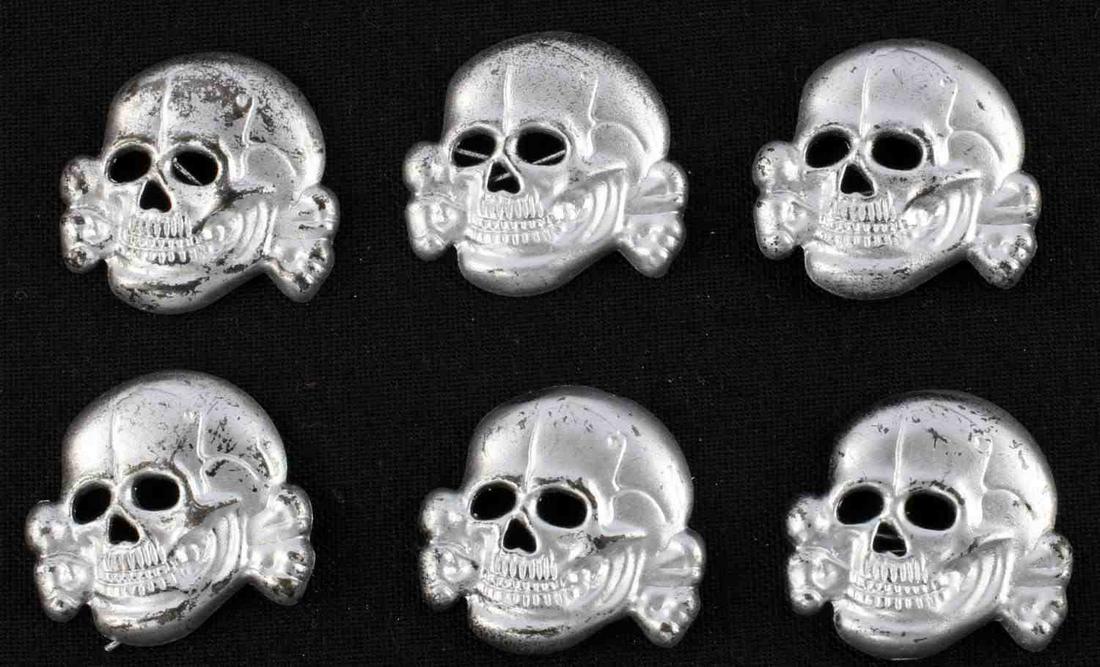 LOT OF 6 WWII GERMAN THIRD REICH TOTENKOPF BADGES: Lot of 6 WWII German Third Reich Totenkopf Skull Badges, all measure approx. 1.25 inches in diameter. Double pin backs with no visible markings. Aluminum construction. Very good condition. Unauthentic