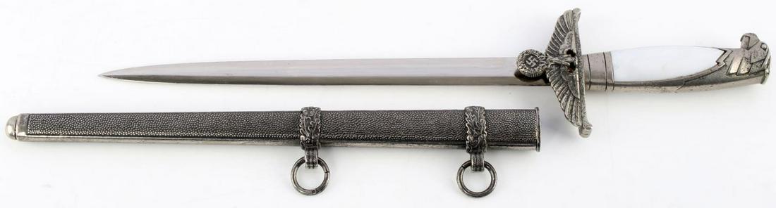 WWII GERMAN NSDAP POLITICAL OFFICIALS DAGGER: Features a 10.25 inch blade, marked Holler Berlin, nickel steel fittings with eagle's head, leather washer, synthetic grip (minor chip), and pebbled steel scabbard. Very good condition. Unauthenticate