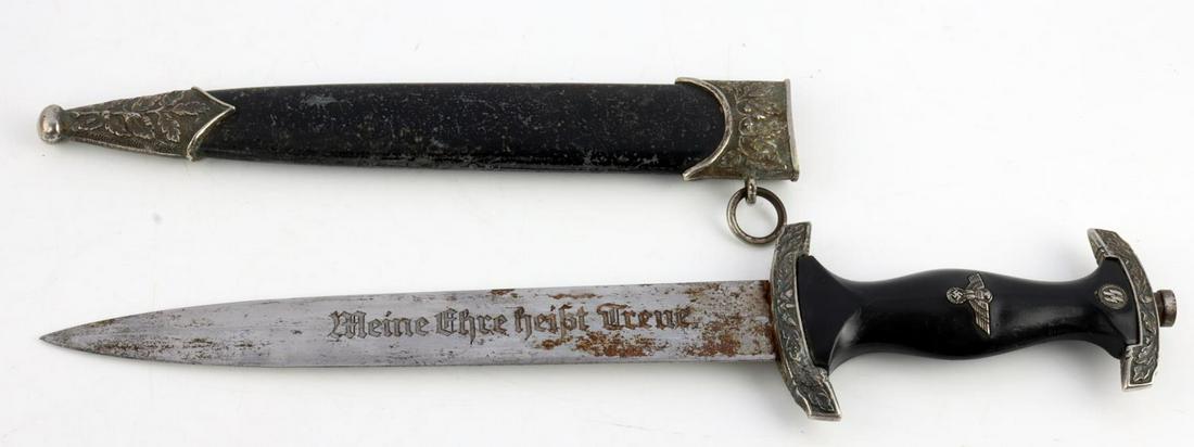 WWII THIRD REICH GERMAN SS OFFICERS DAGGER: Just under a 9 inch blade, marked (Meine Ehre heist Treue) to one side and Himmler phrase and signature to other side, RZM M7/36 marked to ricasso, wood grip, ornate steel fittings, and metal scabbard