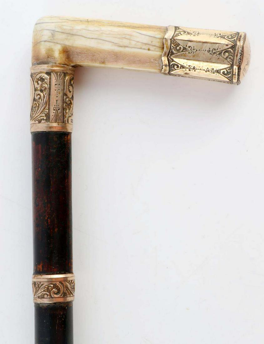 ANTIQUE DATED 1909 GOLD GRIP WALKING CANE STICK: Ivory and gold grip, gold stamped K&K as maker, ebonized wood grip, original ferrule tip, presentation and dated 1909, overall length 35 inches. No International sales, and please know your state regu