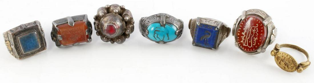 SILVER MEDIEVAL INTAGLIO RINGS METAL DETECTOR FIND: Lot features 6 silver rings and 1 brass ring. Most of which are intaglios and likely traded between Asia and Europe. Stones include turquoise, lapis lazuli, and red quartz. Each ring is engraved on ea