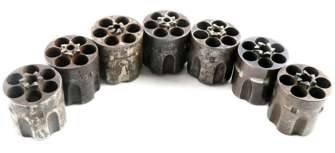 LOT OF 7 ORIG COLT SAA 1ST GENERATION CYLINDERS: All 6-shot revolvers, one is numbered, no other markings. Two are .45 Colt caliber, others are .44-40 caliber. One is cracked, but somewhat intact. Others in fair to good condition. Each measures 1 1/