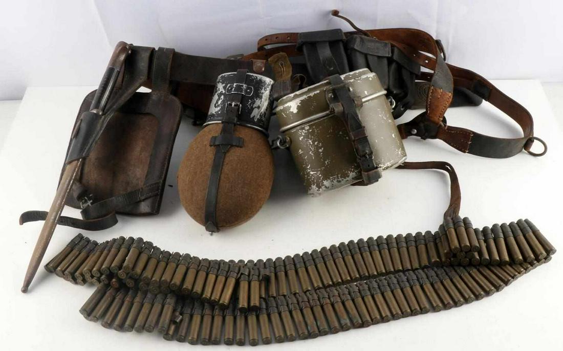 WWII GERMAN THIRD REICH HEER SOLDIER GEAR KIT: Lot features a bayonet, mess kit, ammo pouches, a belt and buckle, empty MG42 shells, and a canteen. Belt marked Deutsches Lede Kernstuk 472 and comes with a steel Gott Mit Uns buckle that has no mark