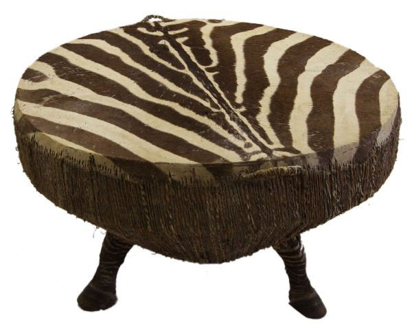 LARGE AFRICAN ZEBRA HIDE DRUM W/ HOOF SUPPORTS: 20th C. 35 inches in diameter with a 22 inch height. Large African drum table constructed from zebra hide with three zebra hooves for support legs. Includes export and shipping paperwork. Overall good