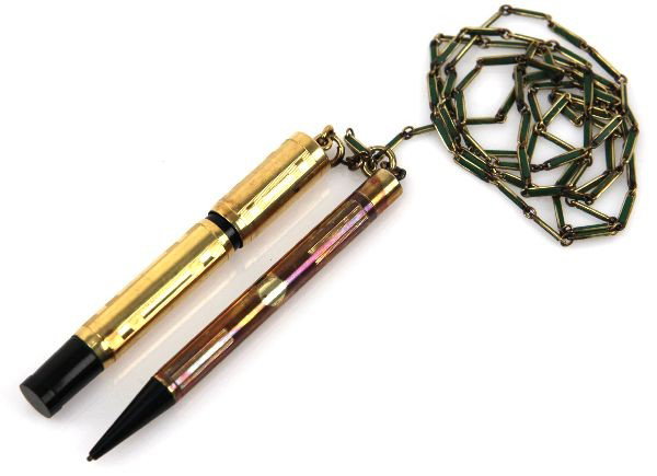 WATERMAN ANTIQUE PEN & PENCIL CHATELAINE SET: A 552 propelling nib Waterman fountain pen and propelling pencil with chatelaine style rings accompanied by original neck holder. Each pen is functional and overall very good with no damage.