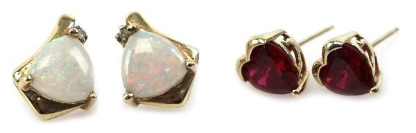 LADIES 14K GOLD SPINEL & OPAL EARRING LOT: One pair of ladies 14K yellow gold heart cut red spinel stud earrings and one pair of milky opal cabochon earrings with diamond accents. . Weight: 5.4 g . Condition: Very good