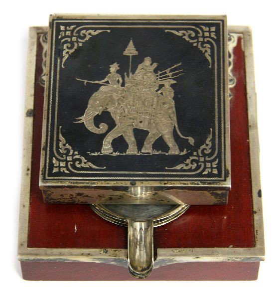 SIAM STERLING SILVER CIGARETTE DISPENSER ASHTRAY: A well executed vintage Siam sterling smoking set with a 3.25x3.25 inch sterling silver enameled cigarette holder/dispenser, match strike, and (3) removable sterling silver ashtrays mounted on a 5x4 i