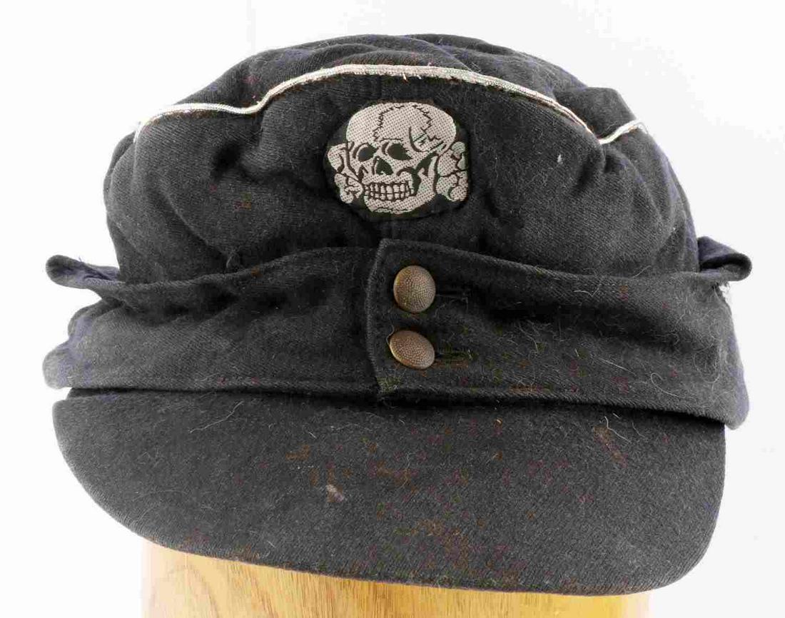 WWII GERMAN THIRD REICH PANZER SS OFFICERS CAP M43: WWII German Third Reich Panzer SS M-43 Officers Cap. The body is a black cotton material. Has a silver bullion piping around the crown. There is a Waffen SS bevo German eagle clutching a swastika in h