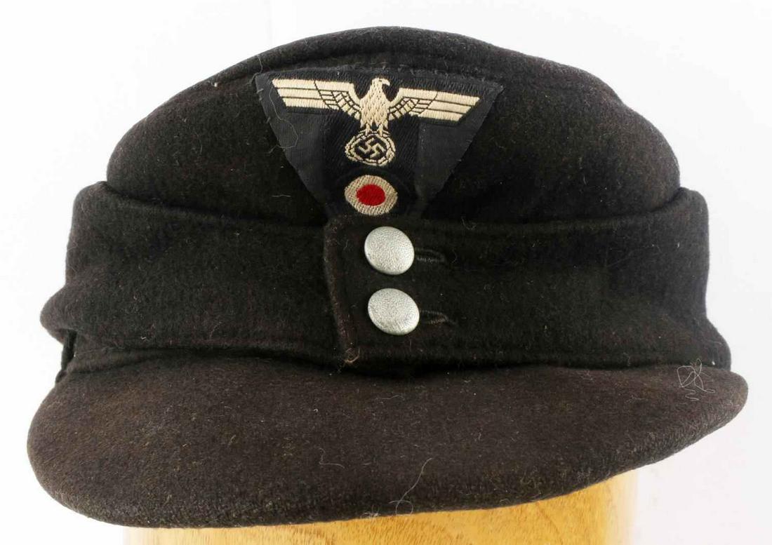 WWII GERMAN THIRD REICH PANZER M43 FIELD CAP: Has a black wool body. Has a one piece Panzer trapezoid machine embroidered bevo woven insignia on the front. It shows a German eagle clutching a swastika in his talon with a cockade below. The cellul