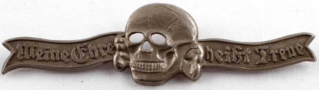 WWII GERMAN THIRD REICH WAFFEN SKULL BREAST BADGE: WWII German Third Reich Waffen SS Skull Mess Dress Breast Badge, measures approx. 4.25 X 1.25 inches. The front shows a skull and cross bones in the center. It reads "Meine Ehre heist Treue" (My Honor