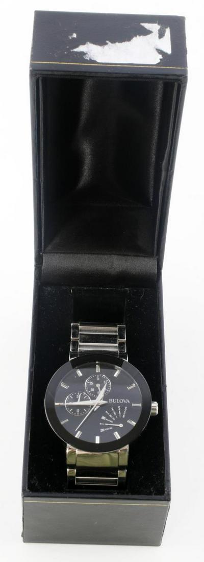 BULOVA FUTURO MODERN MULTI FUNCTION MENS WATCH: Men's Futuro Stainless Steel Strap Watch with Silver-tone stainless steel bracelet and round case. Round black dial with three subdials, logo and stick indices. Quartz movement. Water resistant to 30 