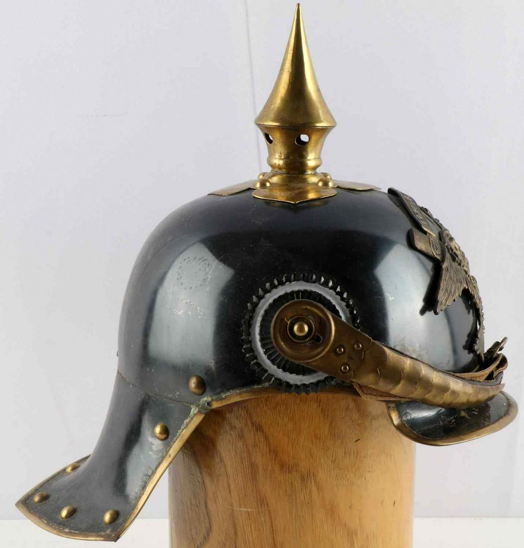 WWI IMPERIAL GERMAN 1915 LOBSTER SPIKE HELMET: The body is a blued steel with a brass Prussian Eagle mounted onto the front. Has the blued steel spike on top. Includes both cockades along with the brass officers chin scales. Very good condition. M