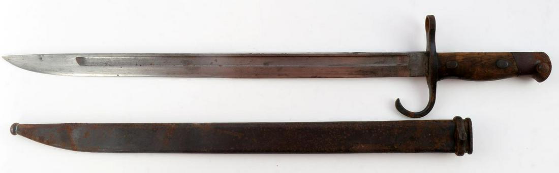 WWII JAPANESE ARISAKA BAYONET WITH SCABBARD: Features a 15 1/2 inch blade with blood groove on each side, minimal pitting, edge wear, wood grip, and steel fittings. Scabbard has heavy oxidation with a bend at the tip.