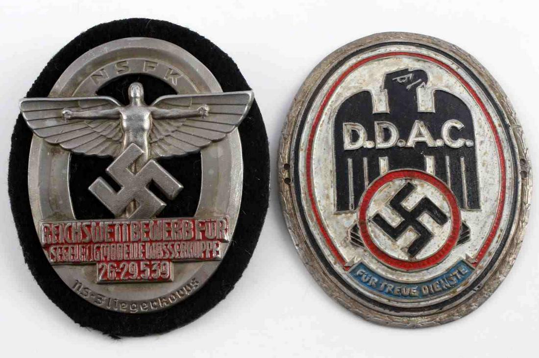 2 WWII GERMAN THIRD REICH NSFK & DDAC SHIELDS LOT: Lot includes; One 1939 NSFK Pilots Championship Shield, safety pin back with no markings. One DDAC (Automobile Association) Plaque, no markings. Each measure approx. 2.5 X 3 inches. Very good conditio