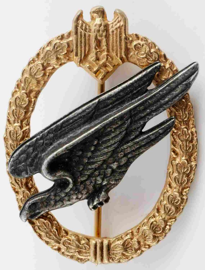WWII GERMAN 3RD REICH LUFTWAFFE PARATROOPER BADGE: Third Reich Luftwaffe paratrooper badge by B & N. Fallschirmjager eagle riveted on oak leaf wreath. Zinc construction. Thin vertical pin with C catch. Very good condition. Measures 2 1/4 inches. Reena