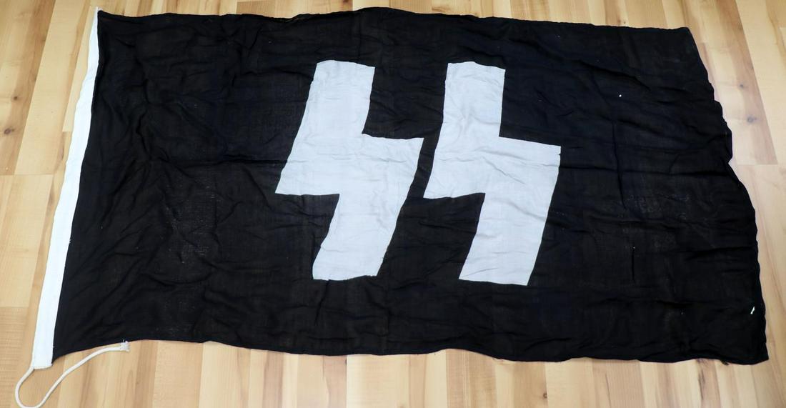 WWII GERMAN THIRD REICH SS DIVISIONAL FLAG: Measures 34 by 51 inches, one piece dyed Runes, stitching on hoist fluoresces. Unauthenticated sold as is.