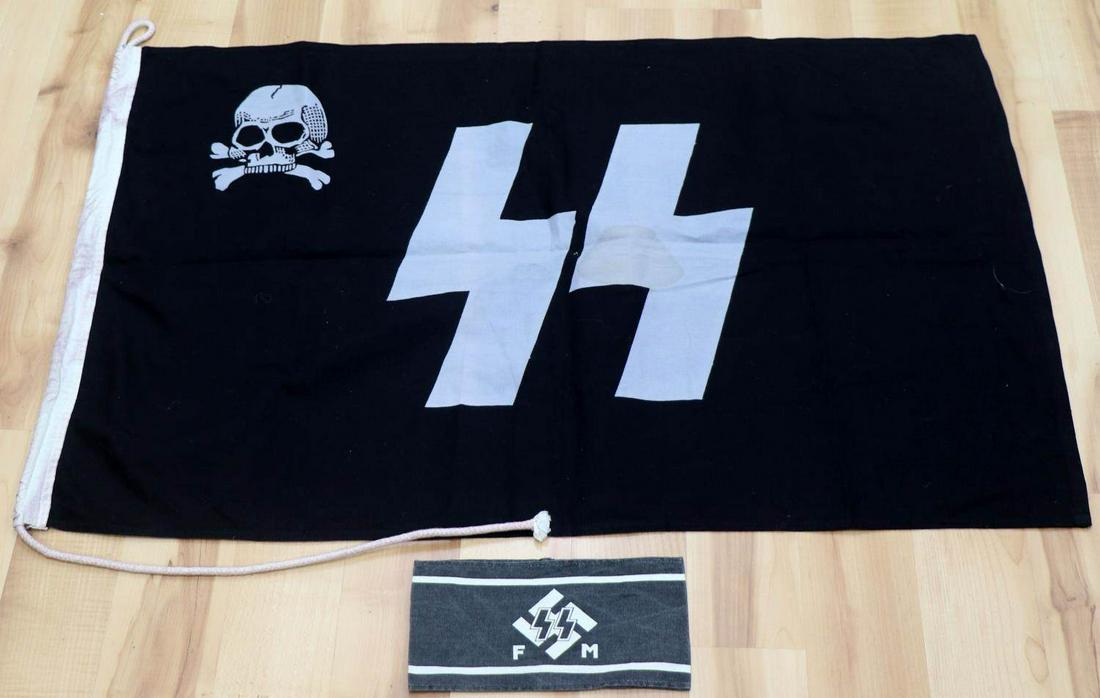 WWII THIRD REICH GERMAN WAFFEN SS FLAG & ARMBAND: Flag with Totenkopf and SS runes, 24 X 36.5 inches, Lab M9/28 and measurement marked to header, header does fluoresce under black light. SS F M armband, 9 X 4.75 inches, RZM label to inside, glue resi