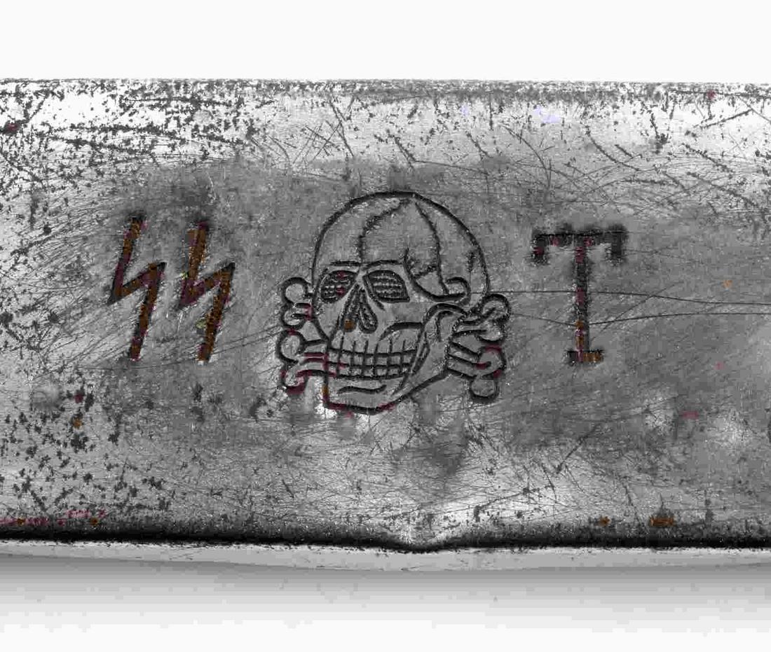 WWII GERMAN THIRD REICH TOTENKOPF TRINKET BOX CASE: WWII German Third Reich Totenkopf Trinket Box / Case, measures approx. 7.25 X 1.75 X .5 inches. Obverse displays SS insignia, skull and T. Opens 180 degrees, no interior markings. Moderate wear interm