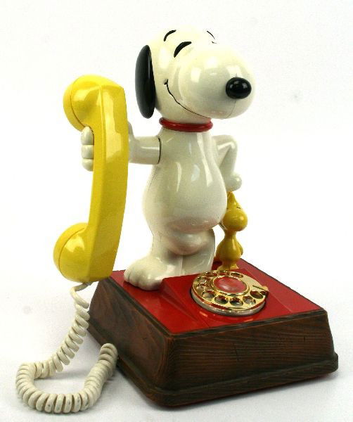 SNOOPY & WOODSTOCK ROTARY DIAL TELEPHONE W/ BOX: Circa 1950-1960's figural Snoopy and Woodstock character rotary dial telephone with original box.14 inches in height. Model # DMH 8010. Overall very good condition with some scratches to faux wood bas