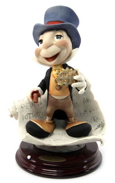 GIUSEPPE ARMANI DISNEY JIMINY CRICKET FIGURINE: 8.5 inch porcelain Jiminy Cricket figurine from Walt Disney's Pinnochio crafted by Giuseeppe Armani. Very good condition with original box.