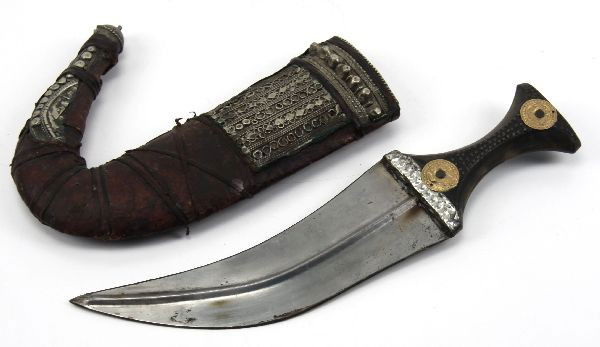 TURKISH DAGGER WITH SCABBARD: A Turkish knife with 8 inch upward curved blade. Leather over wood scabbard, with rough telkari patterns. Crudely fashioned blade of layered steel. No markings, age and time of manufacture unknown.