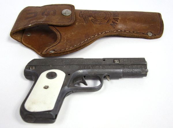 VINTAGE USMC CAP GUN & HOLSTER WITH US MACHETE: A vintage WWII era children's USMC cap pistol, with leather holster bearing USMC logo. In good condition, with slight wear from age. Also included is a US issue Machete, with canvas scabbard. Manufact