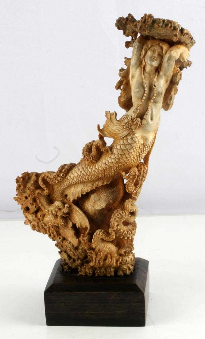 MOOSE ANTLER ORNATE MERMAID & OCTOPUS CARVING: Beautiful hand carved ornate mermaid with octopus. The top features coral structure with a starfish laying on top. The mermaid is intricately carved as hair extends beyond her back along with her fins