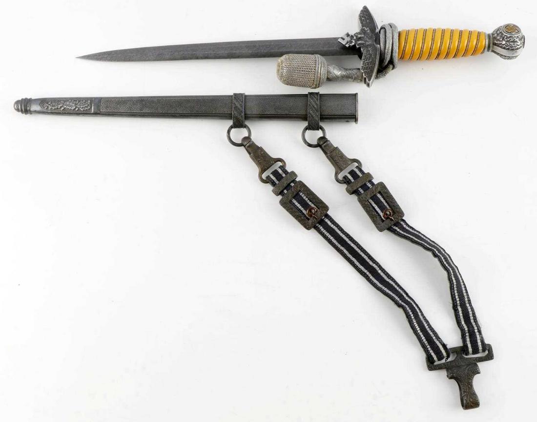 WWII GERMAN 2ND MODEL LUFTWAFFE DAMASCUS DAGGER: 2nd model Luftwaffe dagger. Maiden's Damascus hair steel blade. Aluminum Reichsadler crossguard, aluminum pommel, and bakelite grip. Housed in pebbled scabbard with Luftwaffe hangers. Blade Eickhorn m