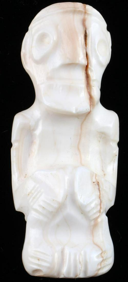 NATIVE AMERICAN TAINO ANTHROPIC ANCESTOR FETISH: Shell Anthropic fetish, possibly an ancestor charm. Depicted as sitting with hands on knees and round eyes typically portraying cohoba intoxication. Length 2.46 inches. Taino Culture of the Caribbean 