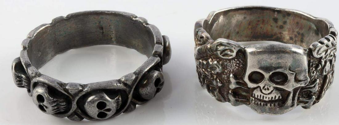 2 WWII GERMAN THIRD REICH SKULL RINGS LOT SIZE 12: Lot of 2 WWII German Third Reich Skull Rings includes; one ring displays 6 skulls on exterior, size 11.5, no interior markings. One ring with skull and oak leaves, size 12, has two makers marks on int