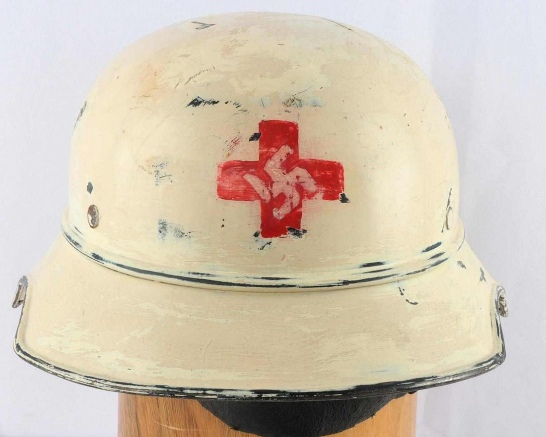 WWII GERMAN REICH RED CROSS CIVILIAN HELMET: WWII German third Reich red cross Luftschutz helmet with inner liner. Exterior has been repainted an off-white color, with a red cross design on front and a decal to the left side. Interior liner has 