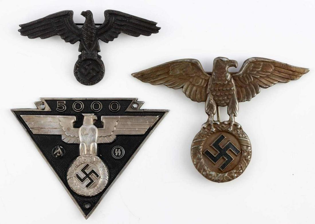 3 WWII GERMAN REICH SS NSFK PINS WITH BREAST EAGLE: Lot features an NSFK helmet pin marked Ges Gesch, an NSFK SA SS commemorative plaque, and a brass breast eagle marked RZM 11/20. Measure 4 - 5 inches.