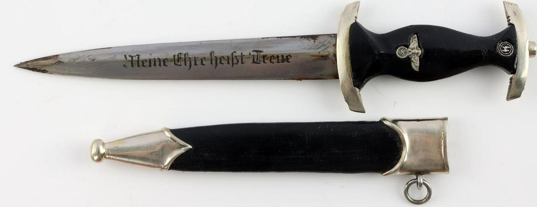 WWII GERMAN THIRD REICH SS MINIATURE DAGGER: WWII German Third Reich SS Miniature Dagger, measures approx. 7.25 inches in total with a 2.25 inch handle and 4 inch blade. Blade reads "Heine Ehre Heist True." Good condition with oxidation. Unauthe