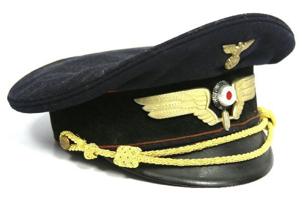 WWII GERMAN RAILWAY VISOR HAT: WWII German Railway peaked visor cap. Railway emblem, with red cockade. Some deterioration to leather band and lining inside hat. Wool in good condition, with no mothing. Overall good condition.