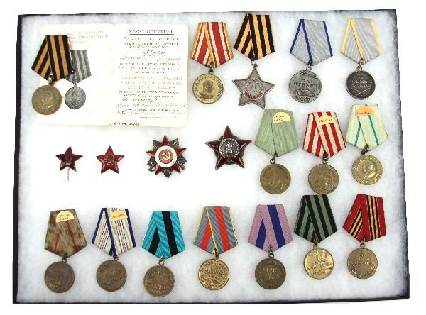 COLLECTION OF VARIOUS SOVIET WWII AWARD MEDALS: Collection if 19 various Soviet Russian medals. Medal for victory over Germany, 1941-1945, with 1946 dated award document; Victory over Japan medal; Medal for Valor; Medal for Combat Service; Order of
