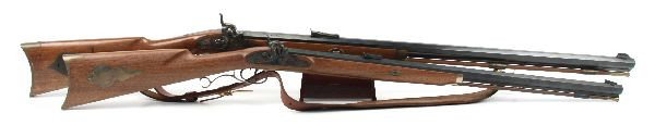 TWO REPRODUCTION PERCUSSION BLACK POWDER RIFLES: Lot of two reproduction percussion black powder rifles, both .45 caliber. Thompson Center Arms rifle, with 28 inch octagonal barrel, double set trigger, and walnut stock. Minor rust spots on barrel, s