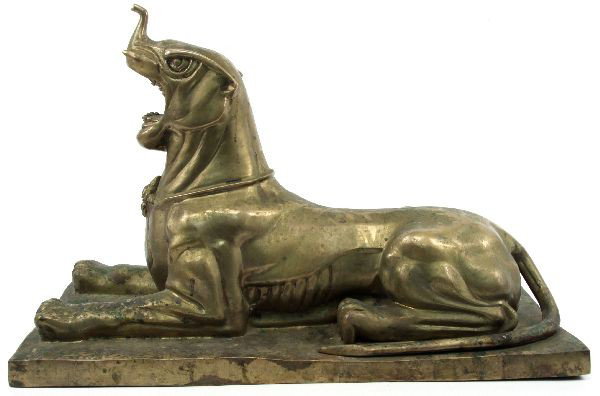 INDIAN MYTHICAL CREATURE BRONZE: Dimensions 12 inch wide by 22 inch long and 10.25 inch tall. Head resembles a dog with a small elephant snout and tusks. Creature is fierce in classic sphinx pose. Some patina and change in color. Ove