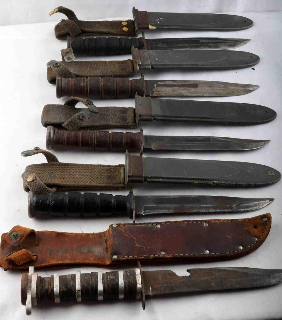 5 VARIENT WWII MK2 USN FIGHTING KNIFE LOT: Includes field altered beer can opener blade Ka Bar in leather sheath, surface rust to blade, Ka Bar with MK2 scabbard, non marked blade or crossguard, MK2 sheath, US Ontario in MK2 sheath, Camillus M