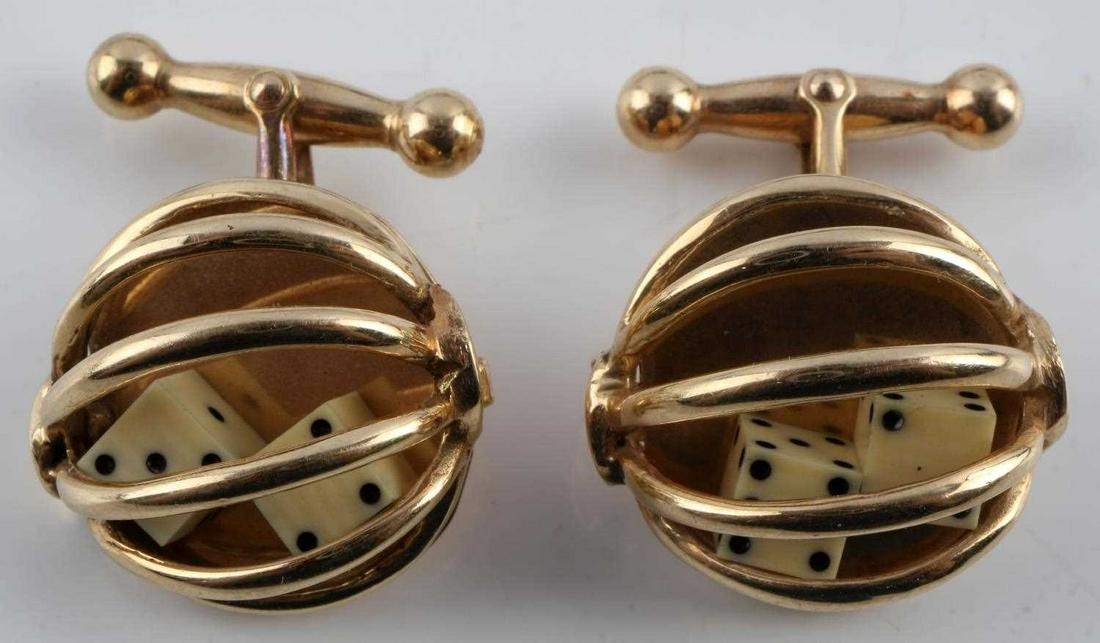 14K YELLOW GOLD CAGE DICE GAMBLERS CUFFLINKS: Cages open to show two playing dice. Dice are carved and painted bone. Cufflink is stamped "14K". In very good conditon. Total weight is 12.1 grams. Cage measures 18.91 millimeters and die measure 4.7