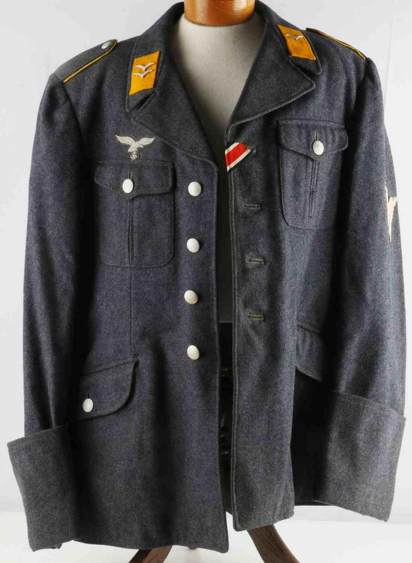 WWII GERMAN THIRD REICH LUFTWAFFE GEFREITER TUNIC: Luftwaffe tunic with Gefreiter rank. Fine blue wool construction with machine woven breast eagle, iron cross ribbon, collar tabs, and shoulder boards. Interior has stamps yet faded. Typical striped ar