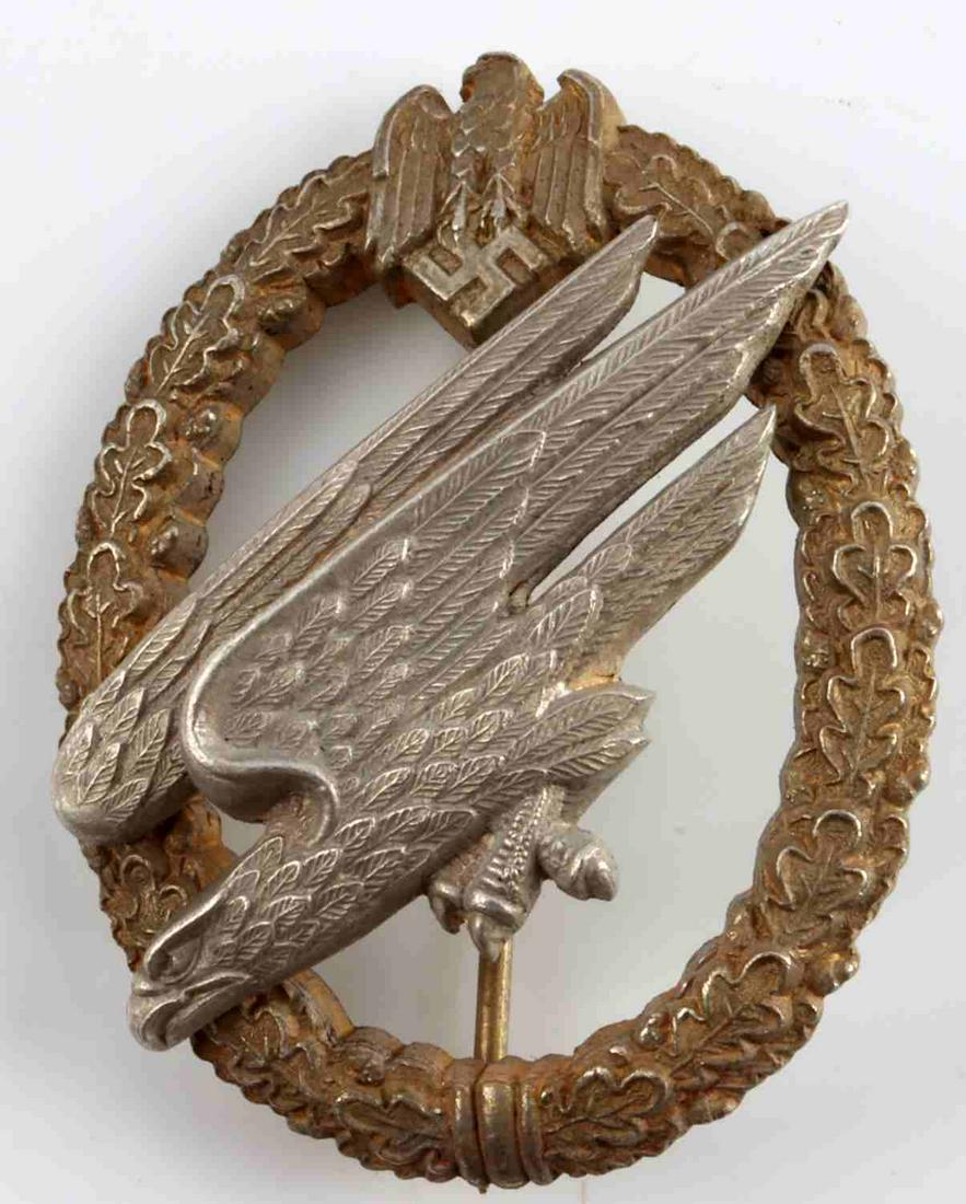 WWII GERMAN REICH LUFTWAFFE PARATROOPER BADGE: Zinc construction. C.E. Junker marked. Most original gilt remaining. Measures 2 1/4 inches. Very good condition. This lot has a reserve.