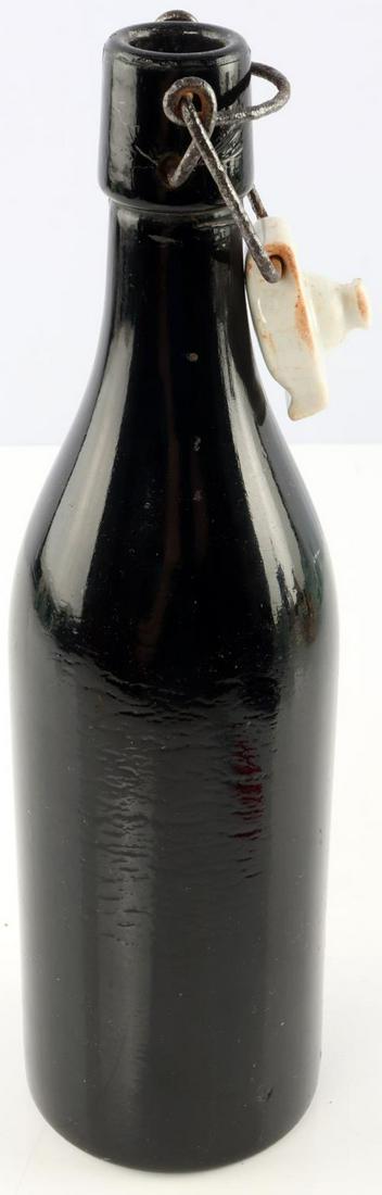 WWII GERMAN THIRD REICH WAFFEN SS BEER BOTTLE: Waffen SS marked to porcelain top. Z marked on bottom. Measures 10 1/4 inches. Very good condition.