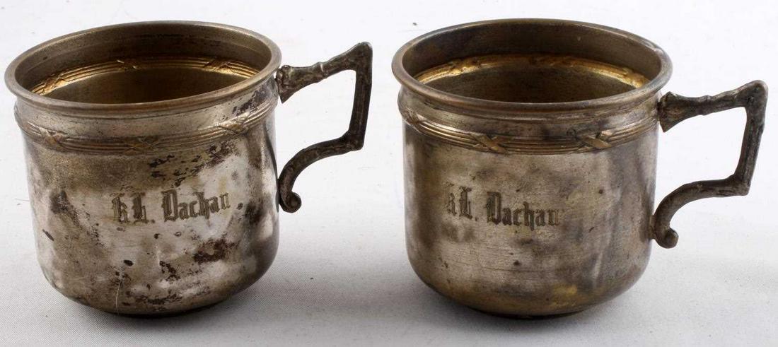 WWII GERMAN THIRD REICH SS DACHAU CAMP CUPS: WWII German Reich SS Dachau camp cups in good condition. Marked "Dachau" on front of cup, marked "SS-Ubungslager, and "Munchen D.R.G.M" on bottom of cup with maker's marks. Both have some blemishing a
