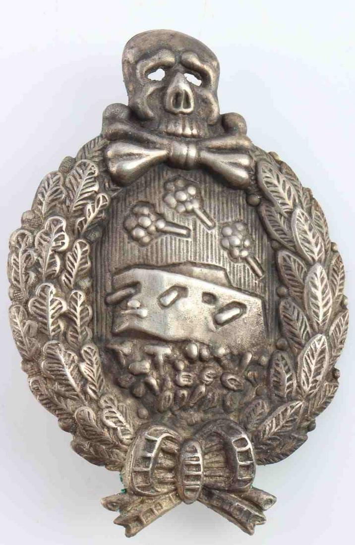 WWI IMPERIAL GERMAN TANK ASSAULT BADGE: Tank in center with totenkopf and oak leaf/laurel wreath. Measures 2 1/2 inches. Vertical pin marked with J. Unauthenticated, sold as is.