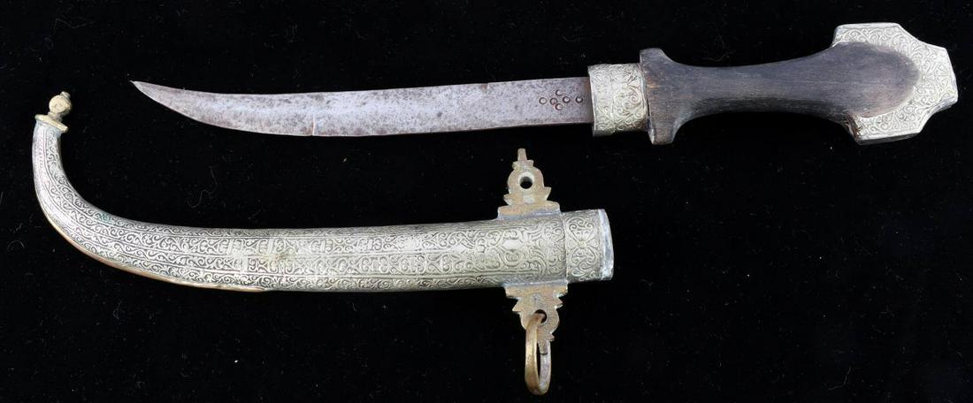 20TH CENTURY MOROCCAN KOUMMYA DRESS DAGGER: 20th century Moroccan Koummya dress dagger and scabbard in good condition. Dagger measures about 9 inches long in total and features a design on ricasso. Blade has significant blemishing and bruising