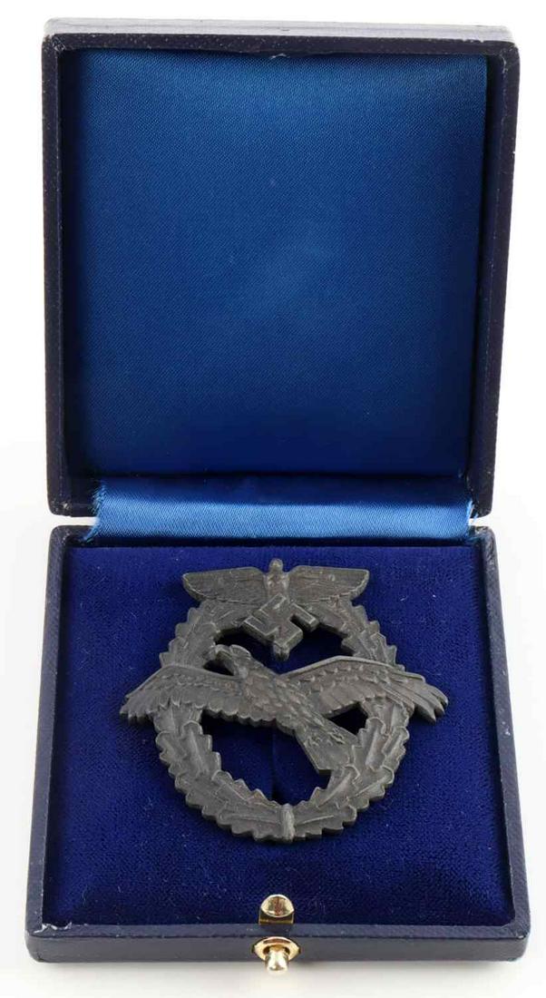 WWII GERMAN REICH CASED NSFK GLIDER PILOTS BADGE: WWII German Reich cased NSFK glider pilot's badge in good condition. Marked on reverse "GM No 111241 "Vertical pin back on reverse. Unauthenticated, sold as is.